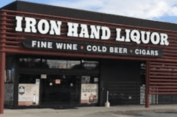 A large building with a sign that says iron hand liquors.